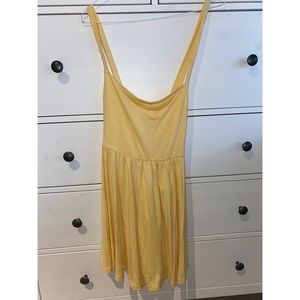 NWOT Urban outfitters soft yellow tie back romper.